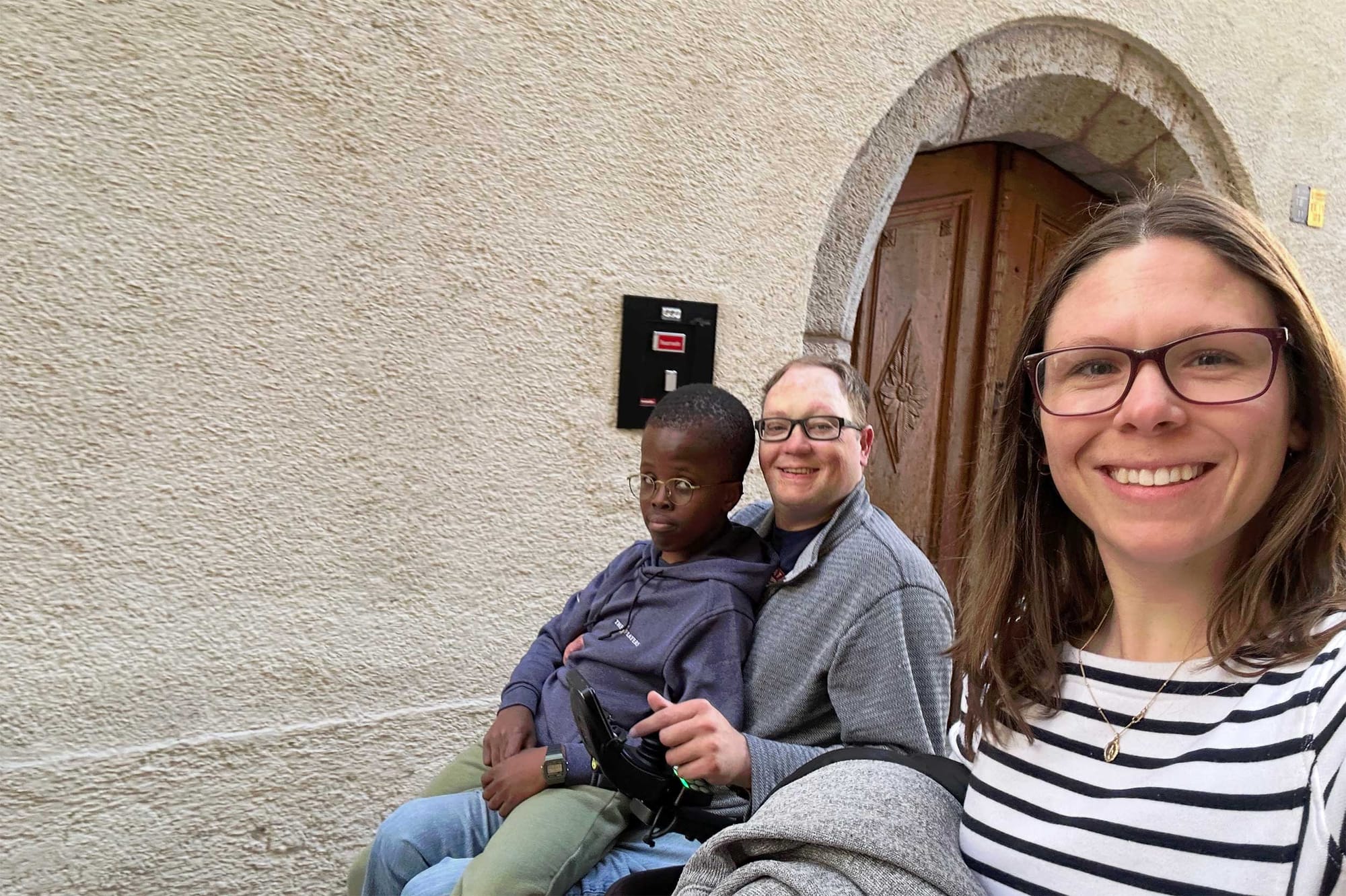 Walking down a historic street in Austria, Stevie snaps a selfie with Robert sitting on John's lap.