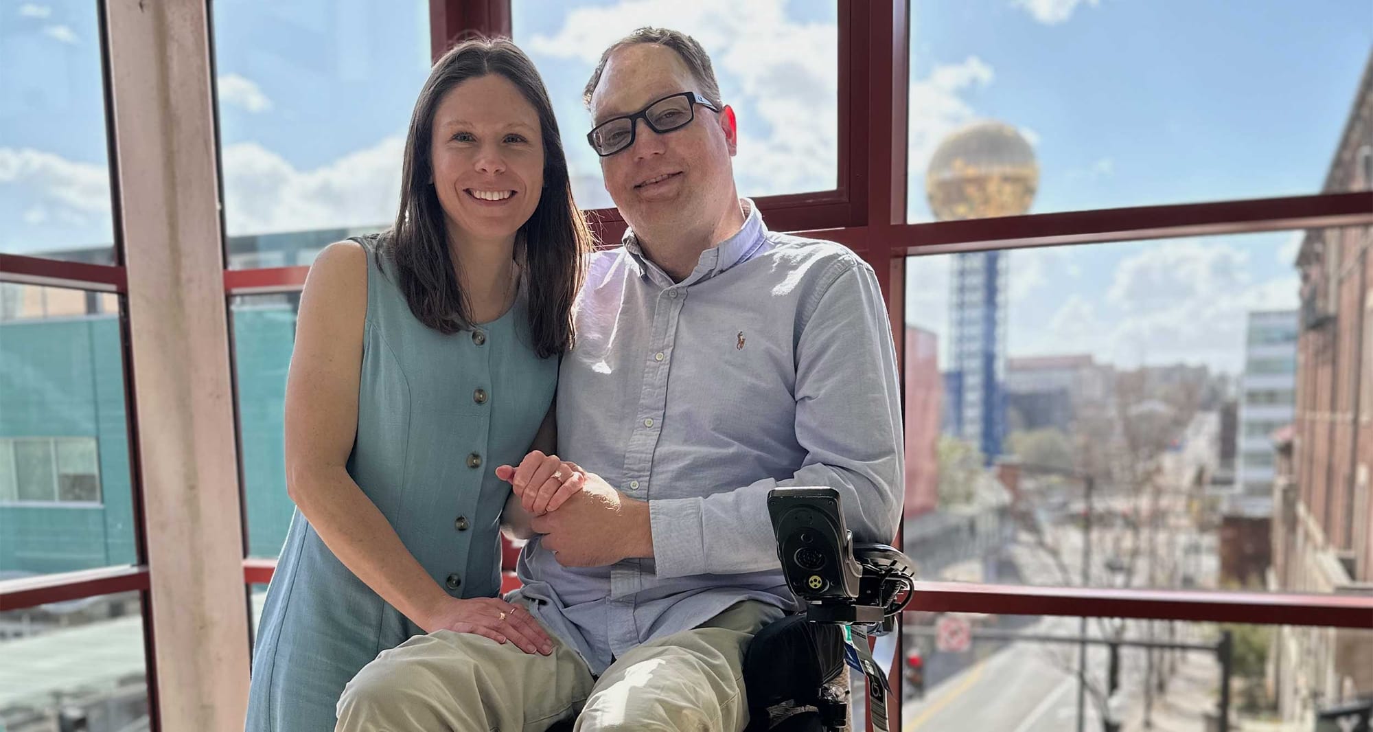 John and Stevie pictured with the Knoxville gold ball and skyline in the background.