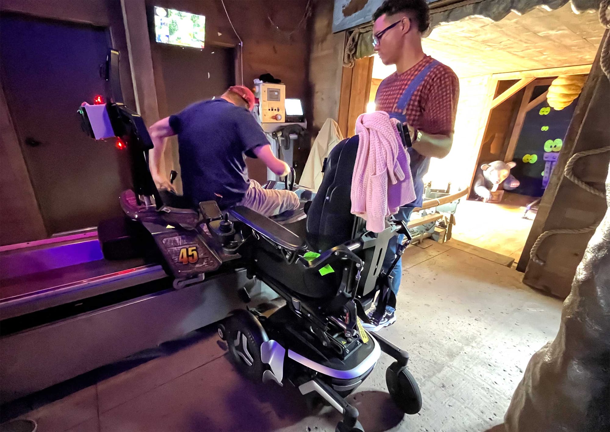 John transferring from his power wheelchair into the coaster seat.