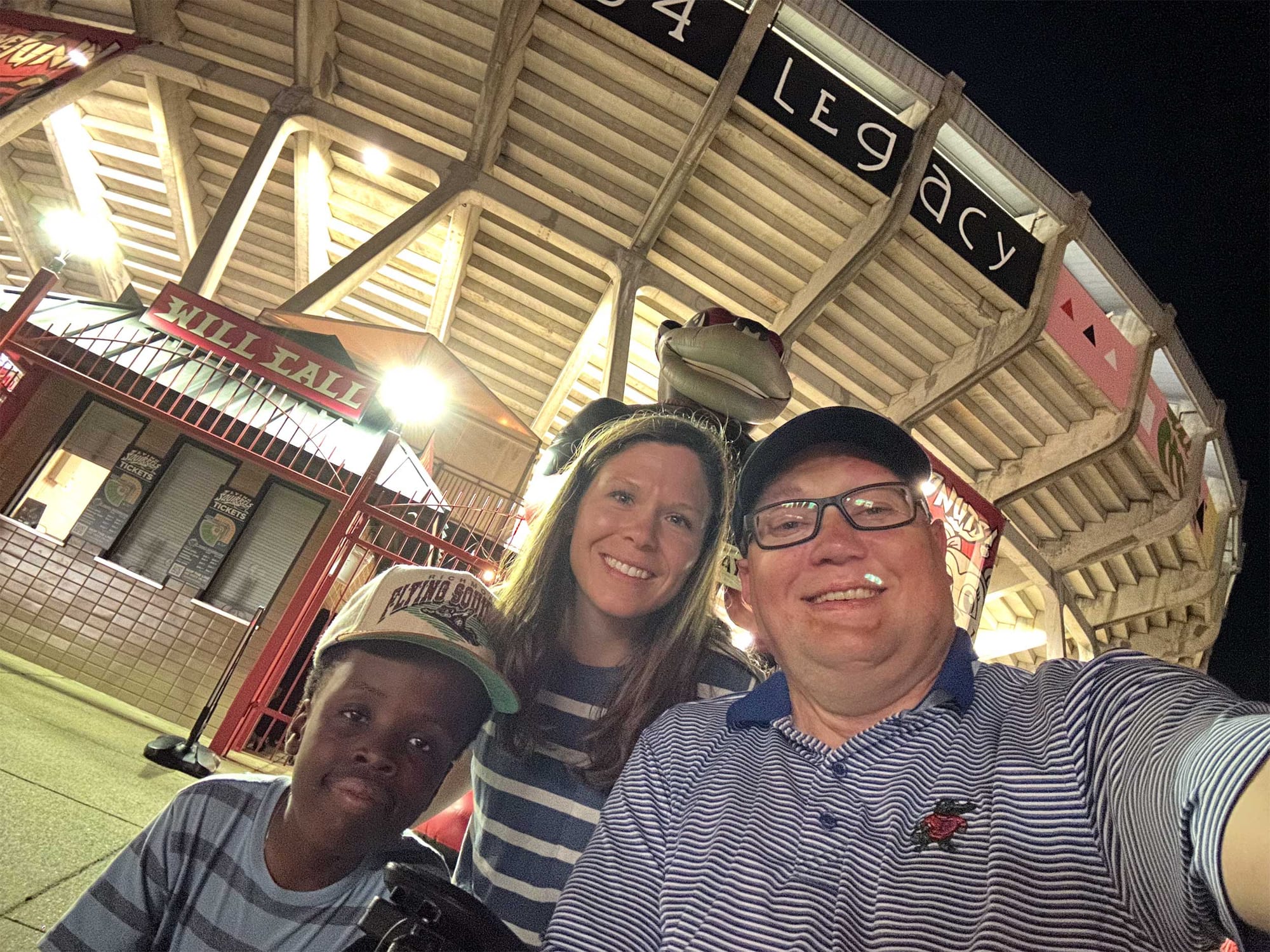 Selfie of John, Stevie and Robert outside stadium after baseball game.