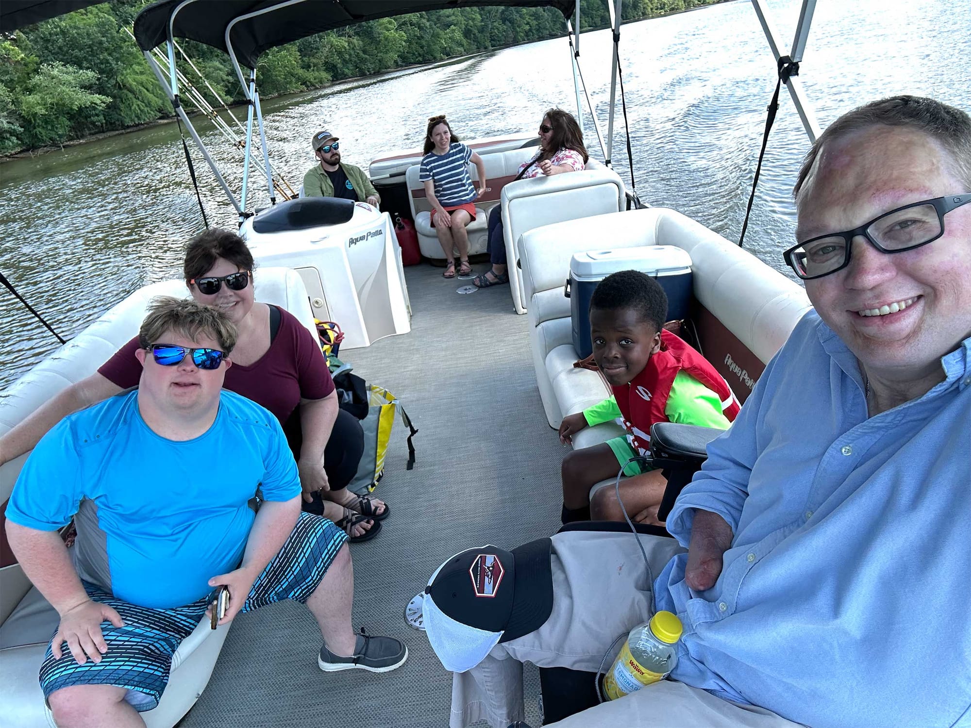 Selfie of John with family and friends on a boat.