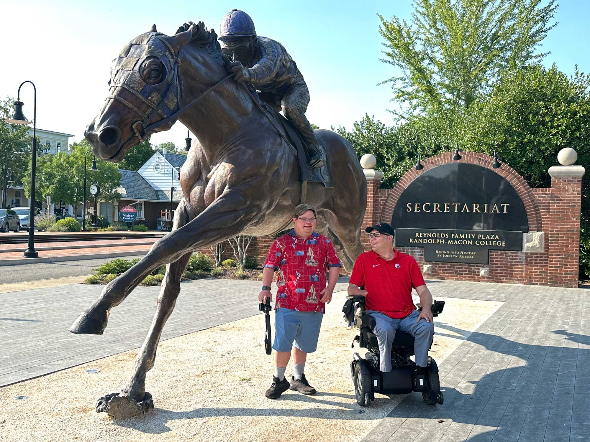 John seated in his wheelchair underneath the Secretariat statue.