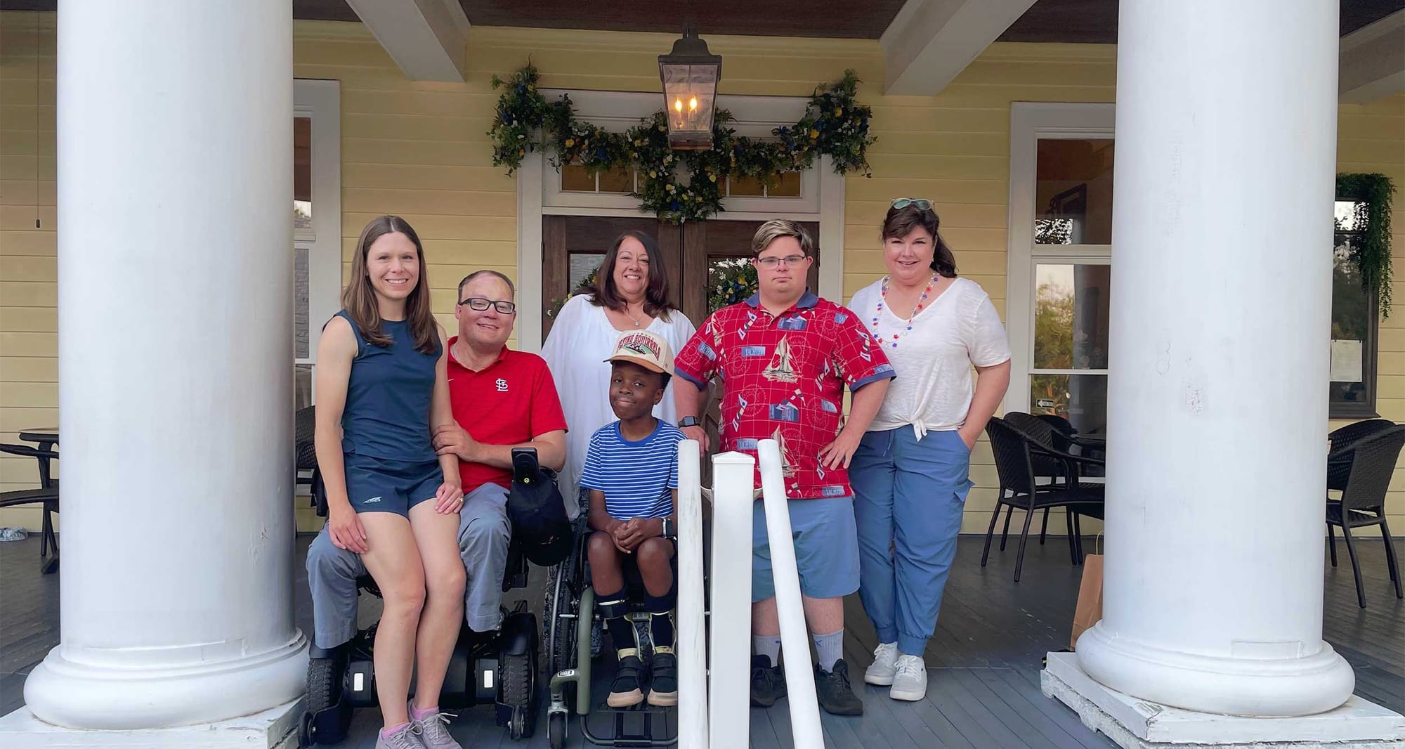John, Stevie, Robert and friends pictured on the porch of a historic inn.