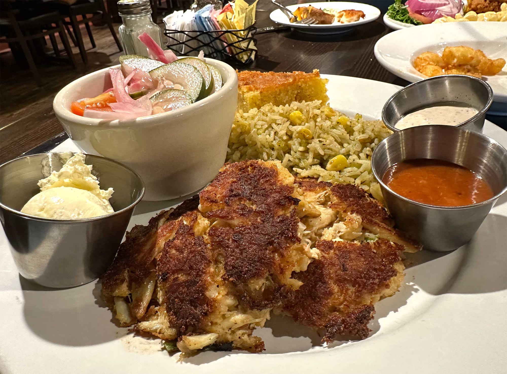 Crab cakes with rice and cornbread.