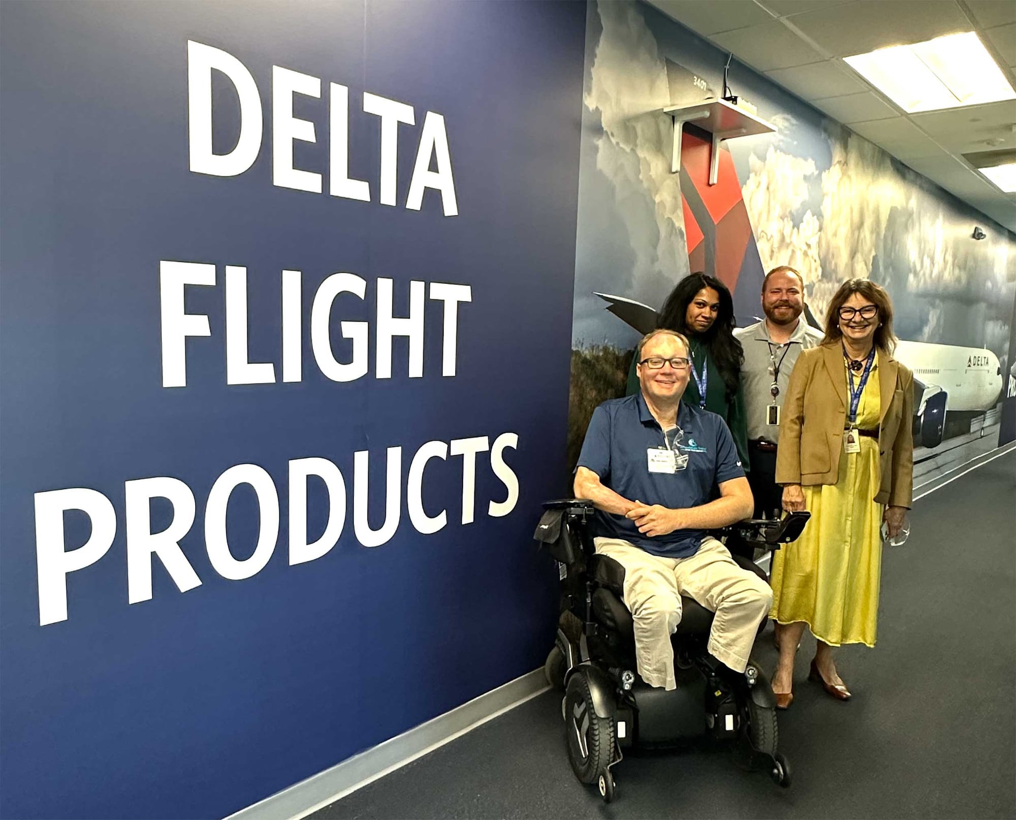 John seated in his wheelchair alongside members of the Delta Flight Products team at their headquarters in Atlanta.