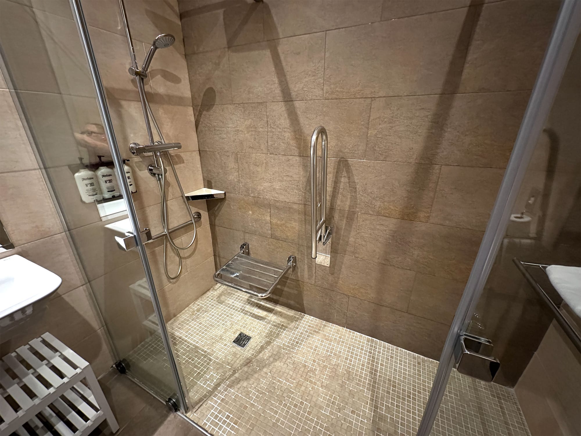 Roll-in shower with grab bars and seat.