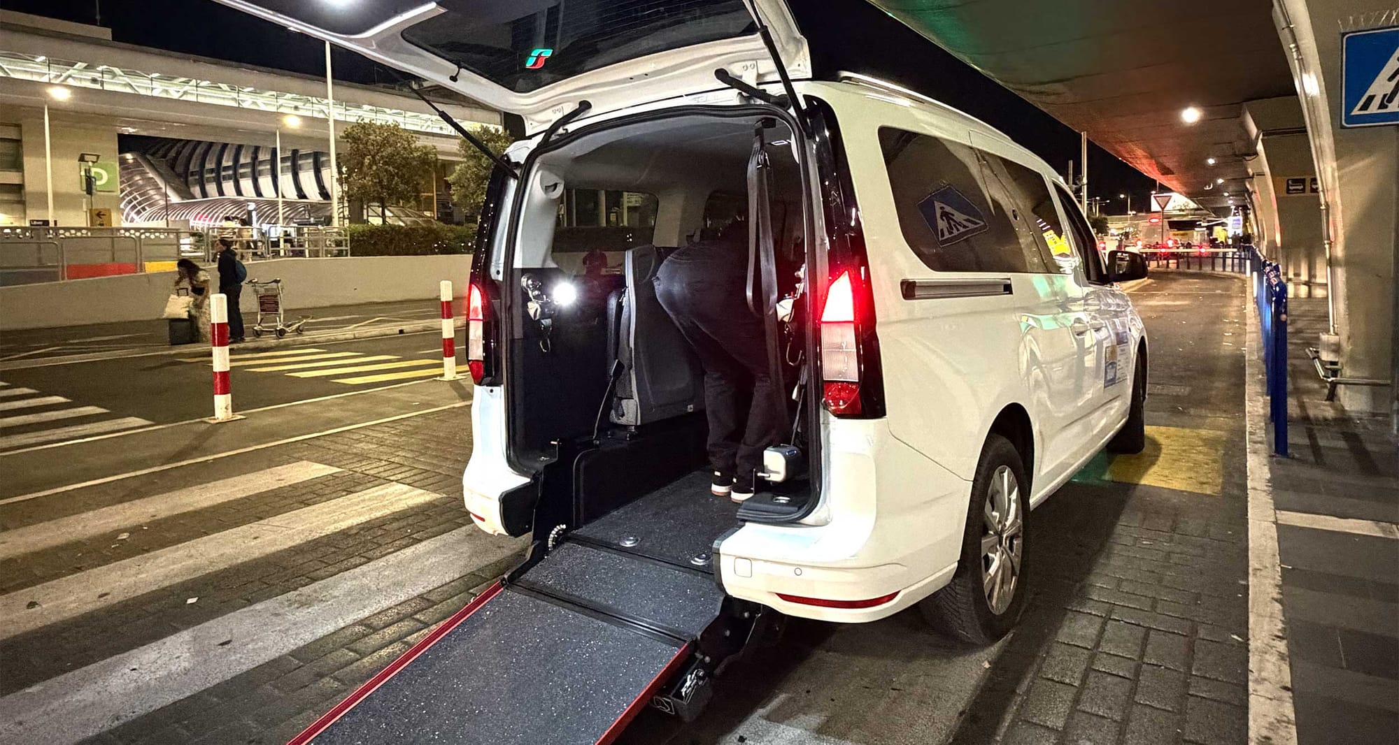Rear-entry wheelchair taxi with ramp in Rome, Italy.