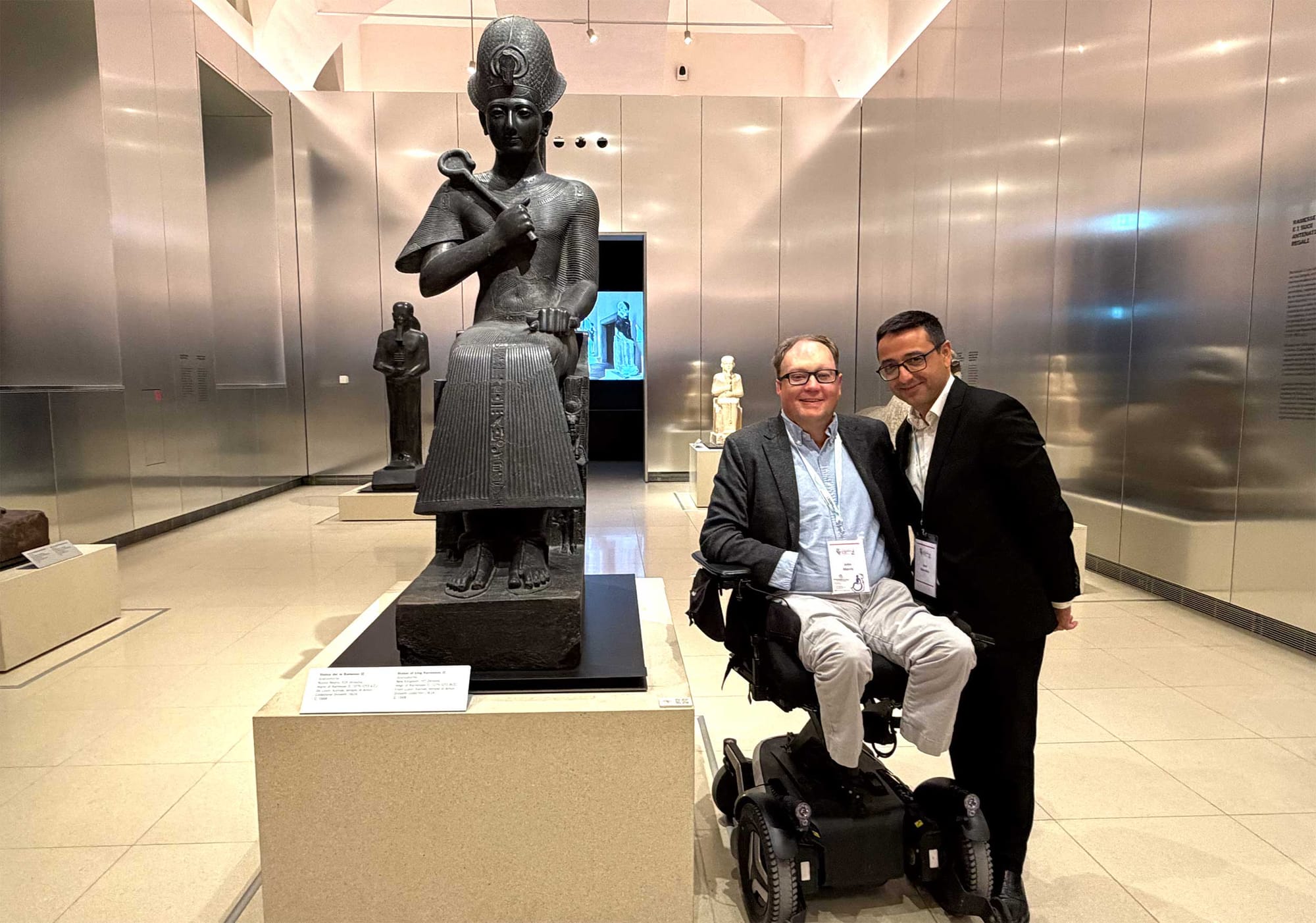 John pictured with a colleague in front of the statue of Egyptian pharaoh Ramses II.