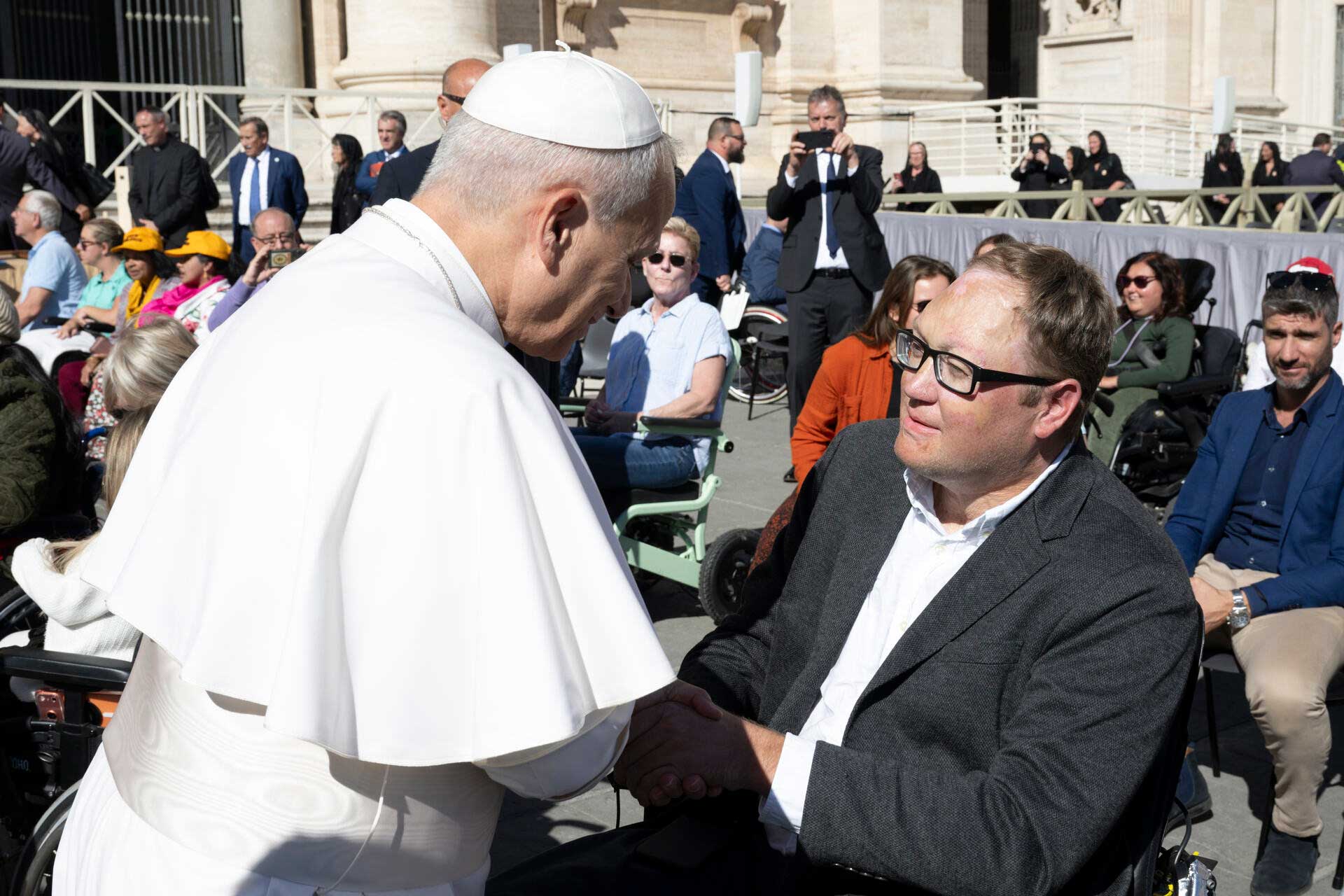 John shaking hands with Pope Leo in St. Peter's Square.
