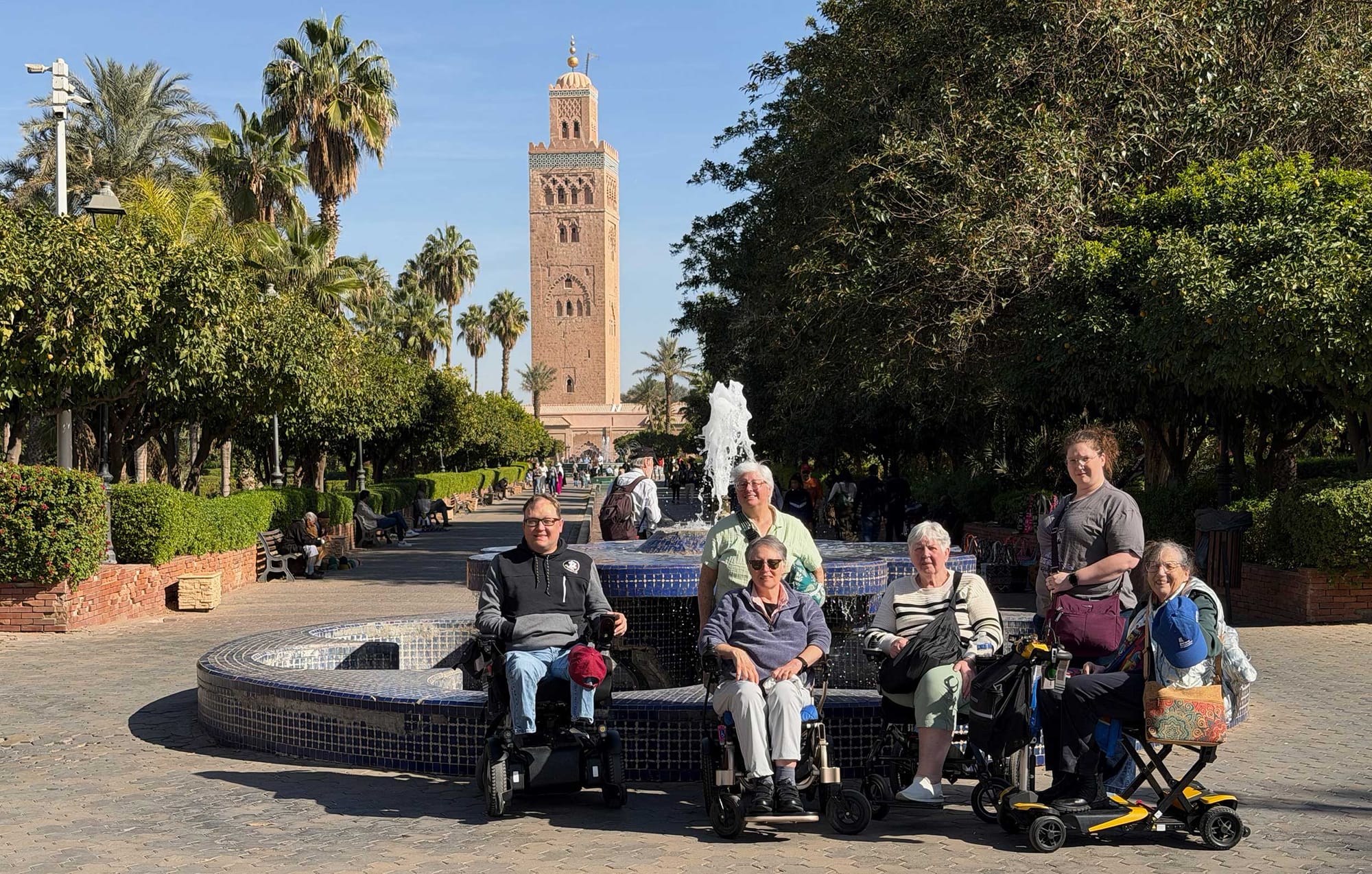 Group of wheelchair users in front of a fountain in Morocco.