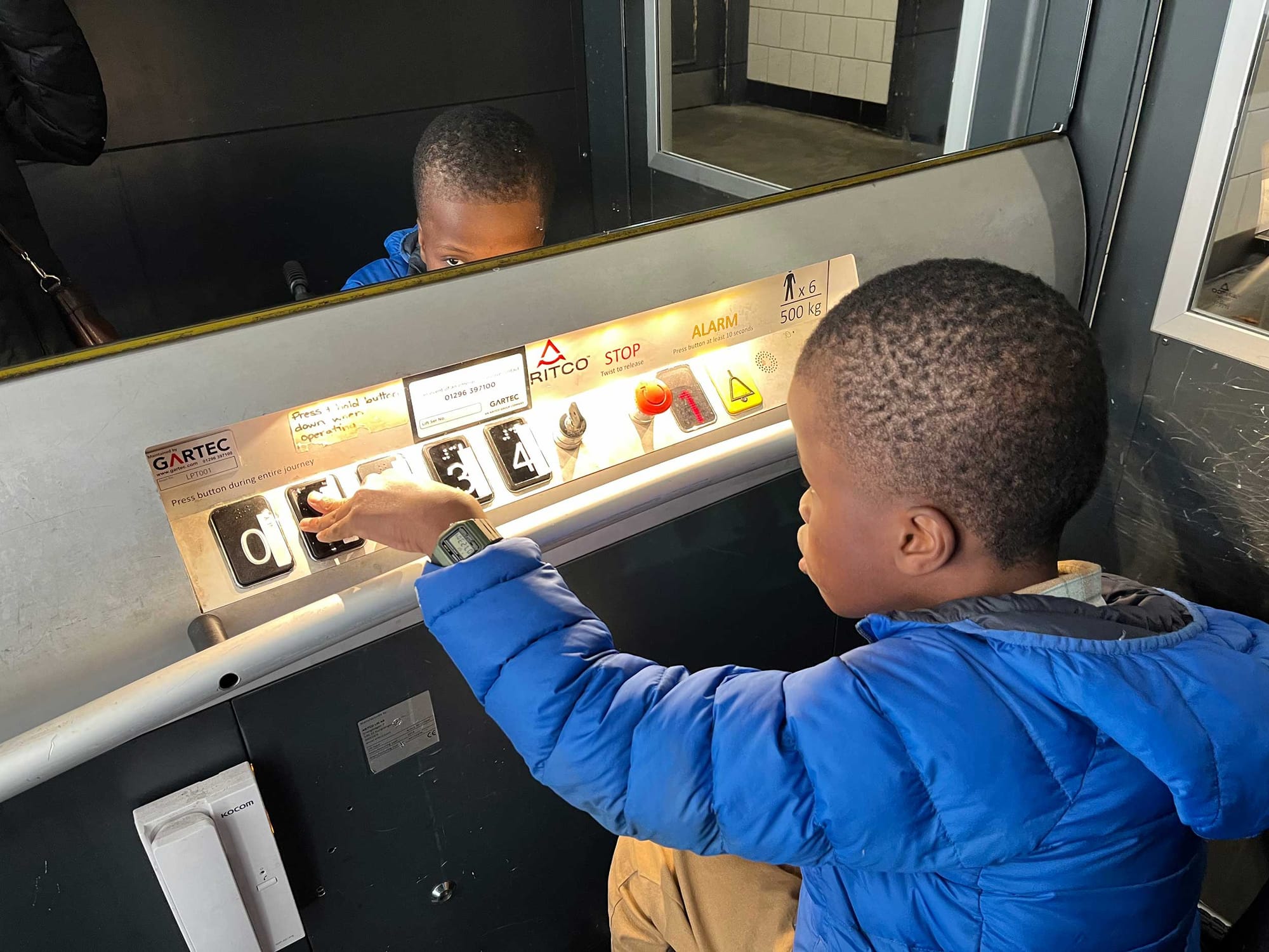 Robert operating a wheelchair lift while seated in his manual wheelchair.