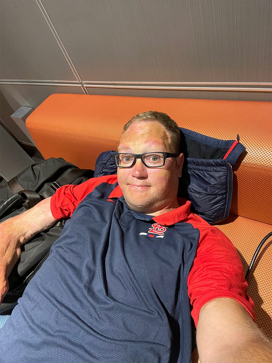 Selfie of John laying on a chair on the airport.