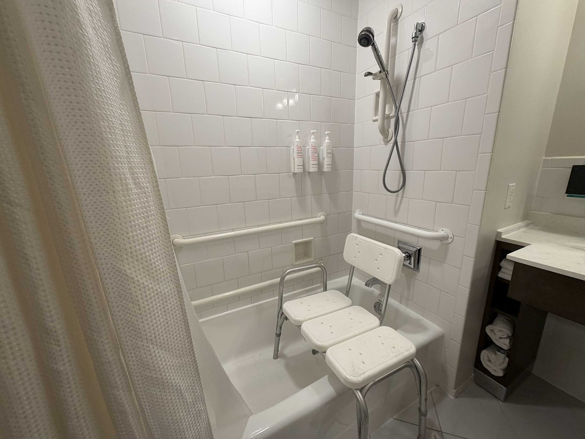 Portable shower chair inside bathtub.