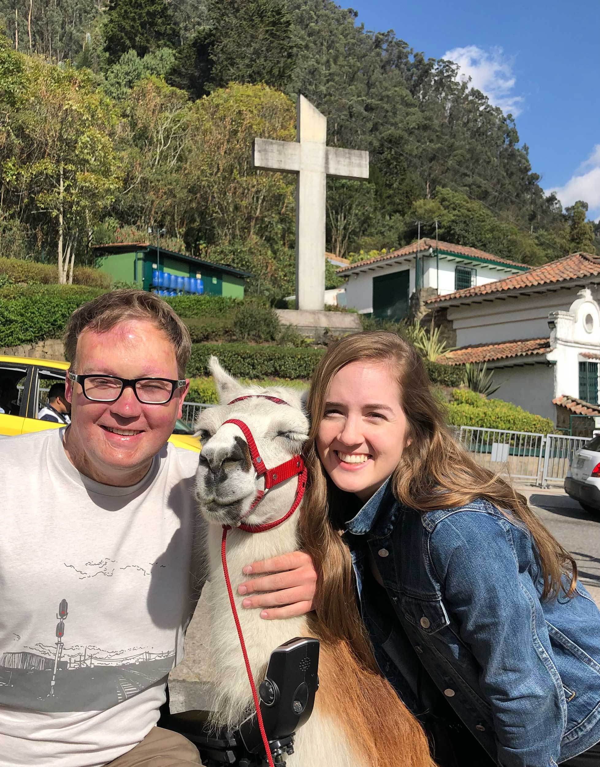 John and his sister posing with a llama.