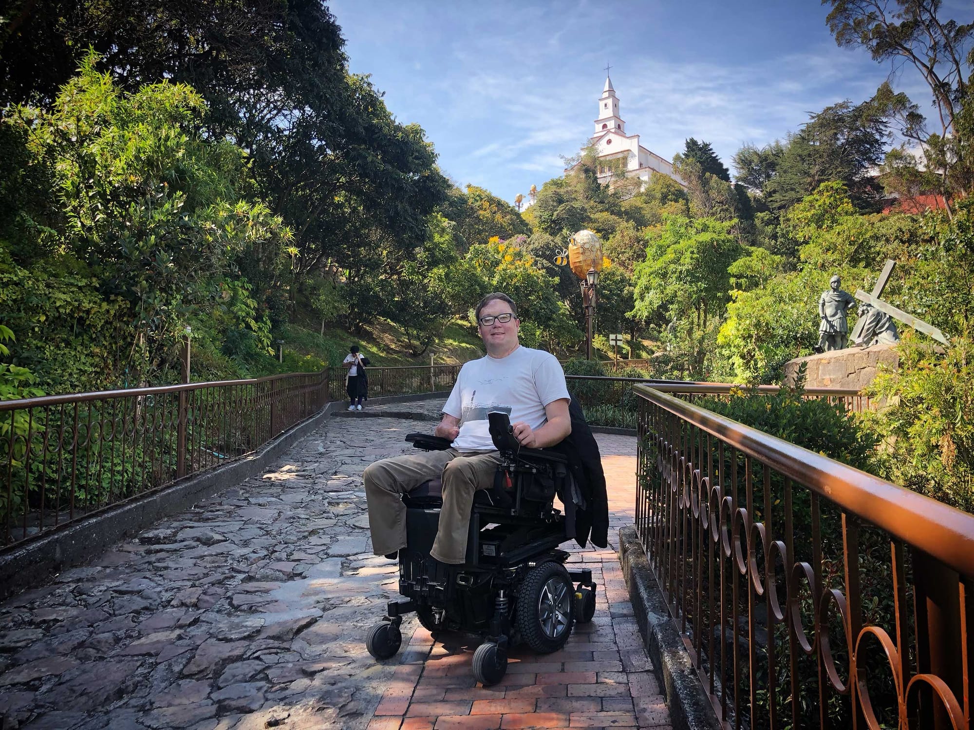 John in his wheelchair on a path up the mountainside.