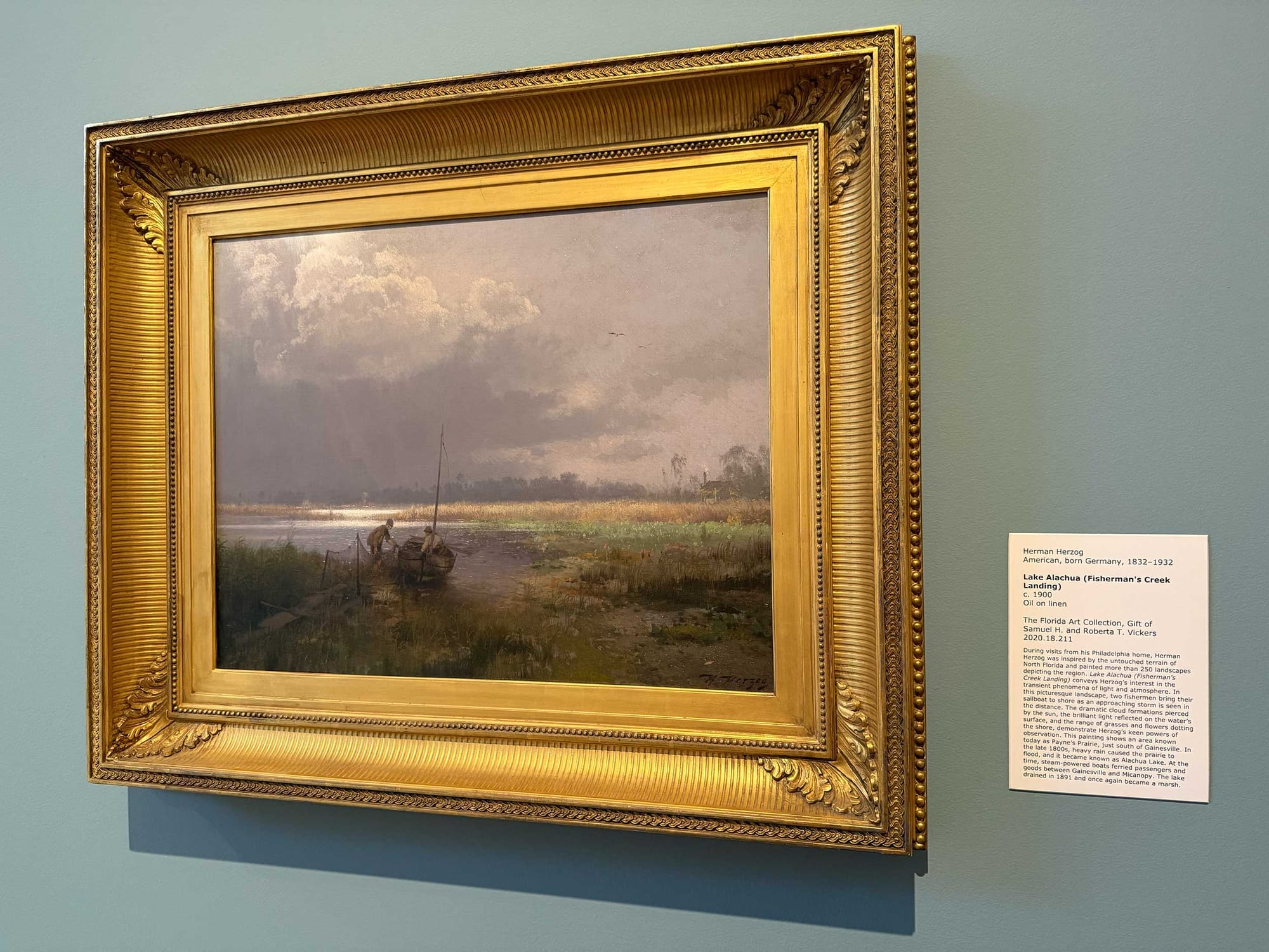 Painting of a man taking a boat out onto Lake Alachua.