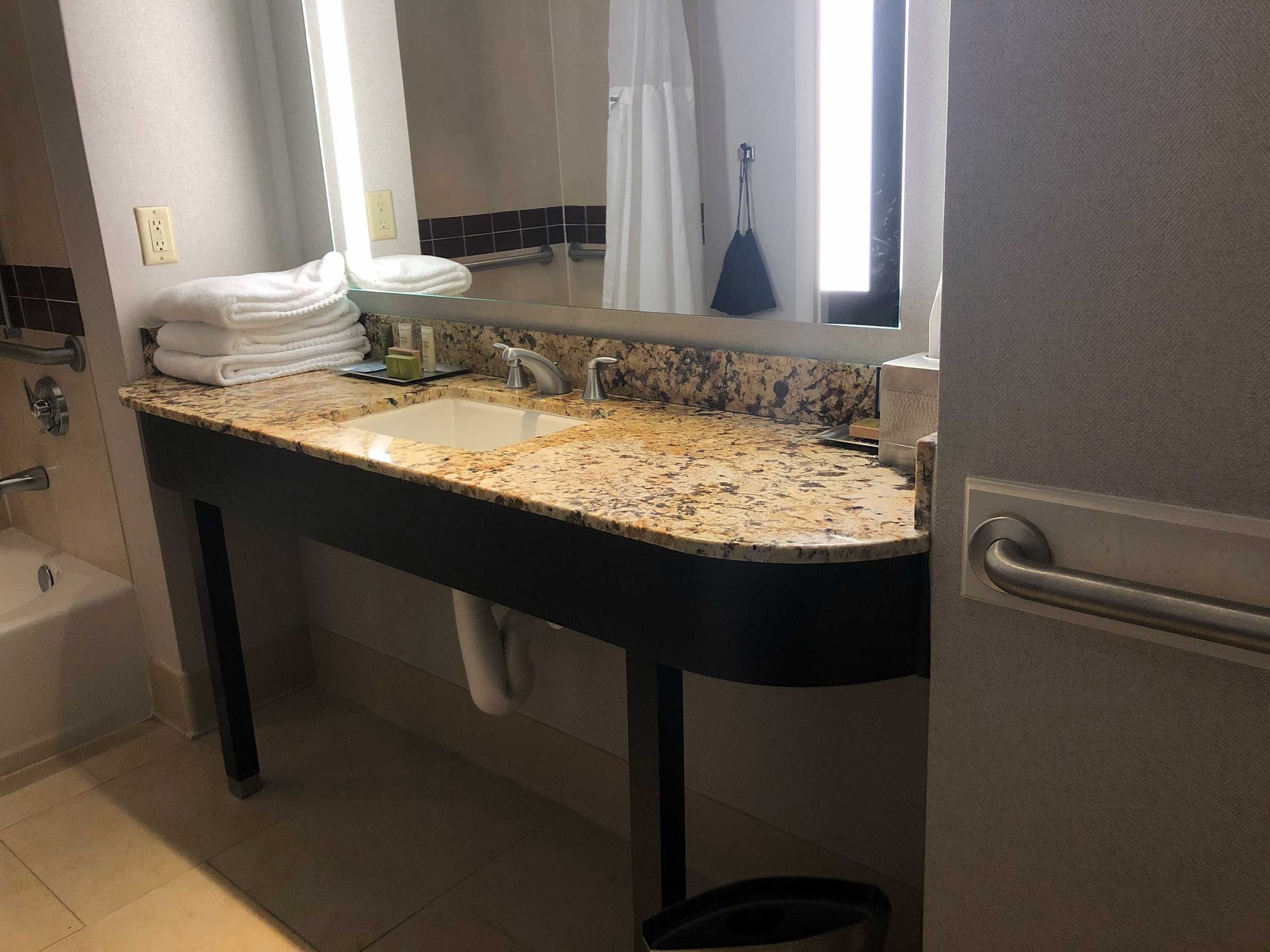 Open vanity with granite countertop.