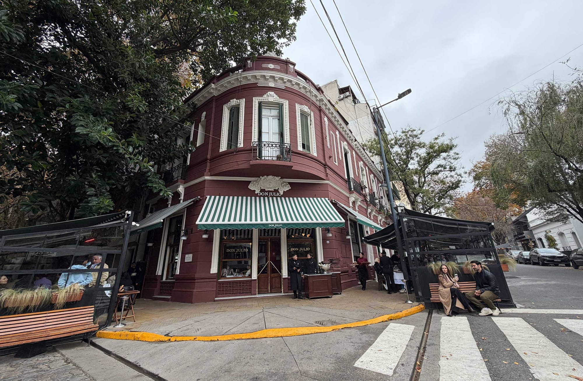 Exterior of restaurant in historic brick building on street corner.