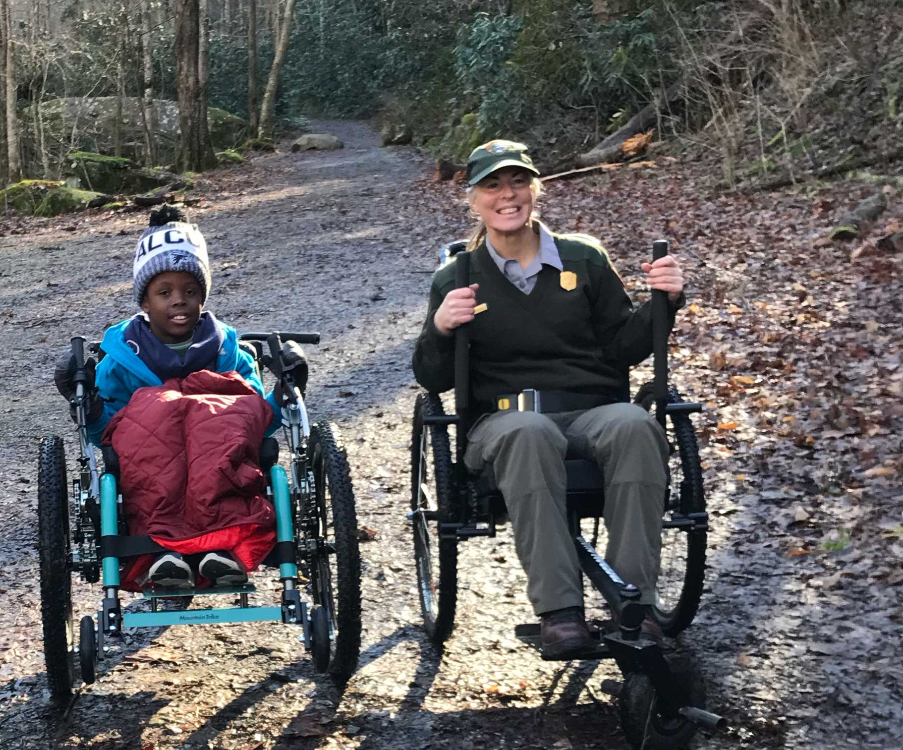 Robert in his mountain trike with a park ranger who is also using a trike.