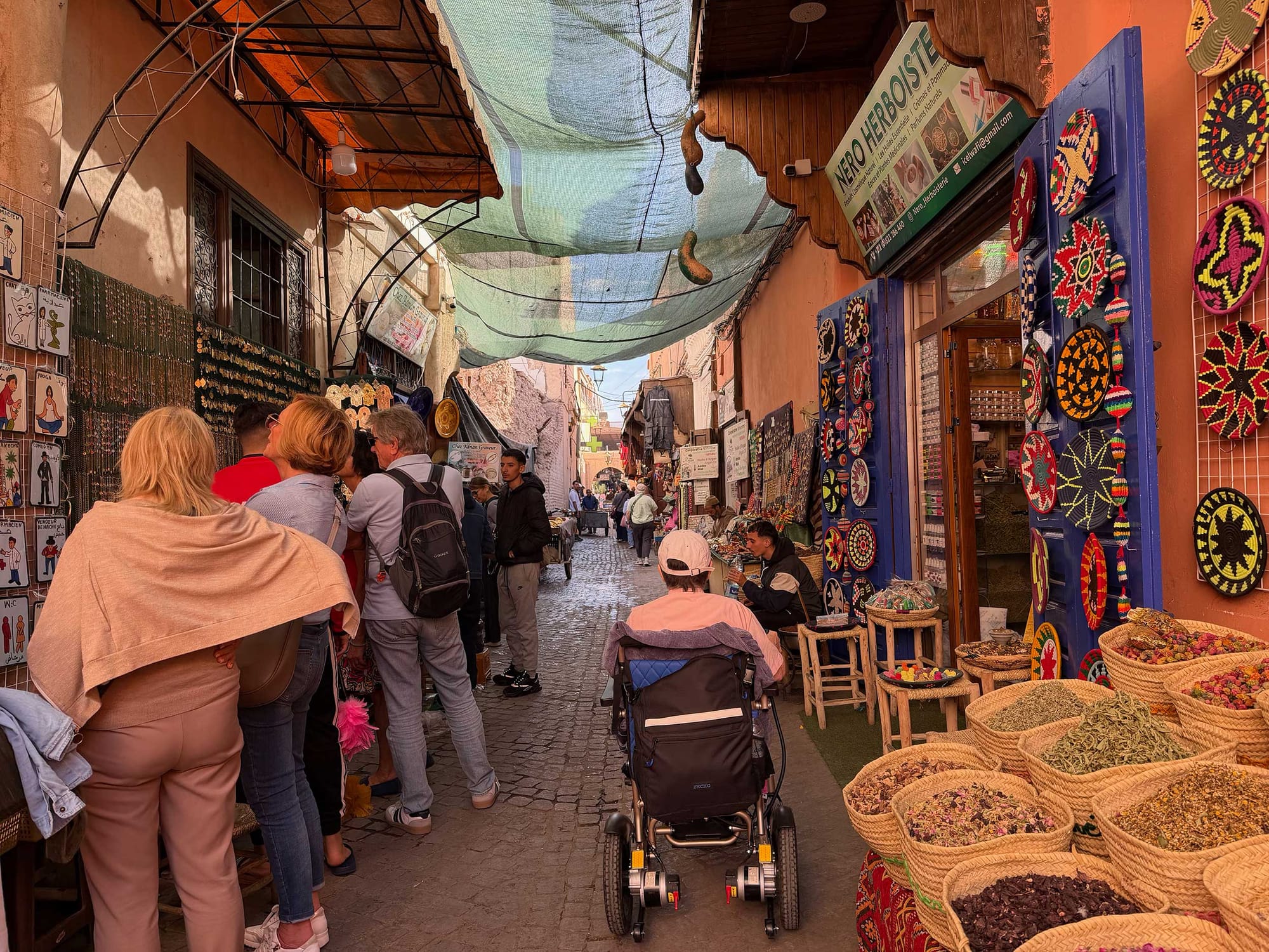 Wheelchair user passing through marketplace.