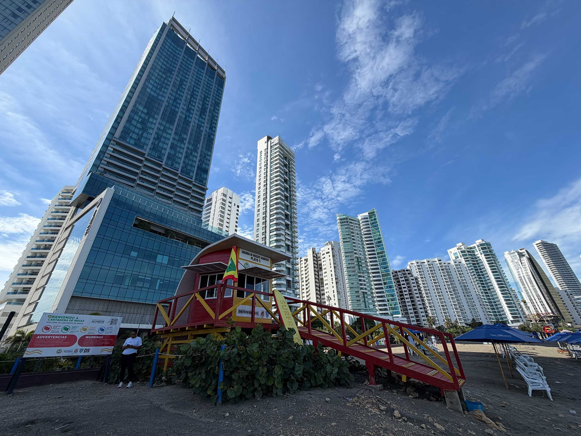 Red and yellow lifeguard station at the base of Bocagrande's high-rise hotel and condo towers.