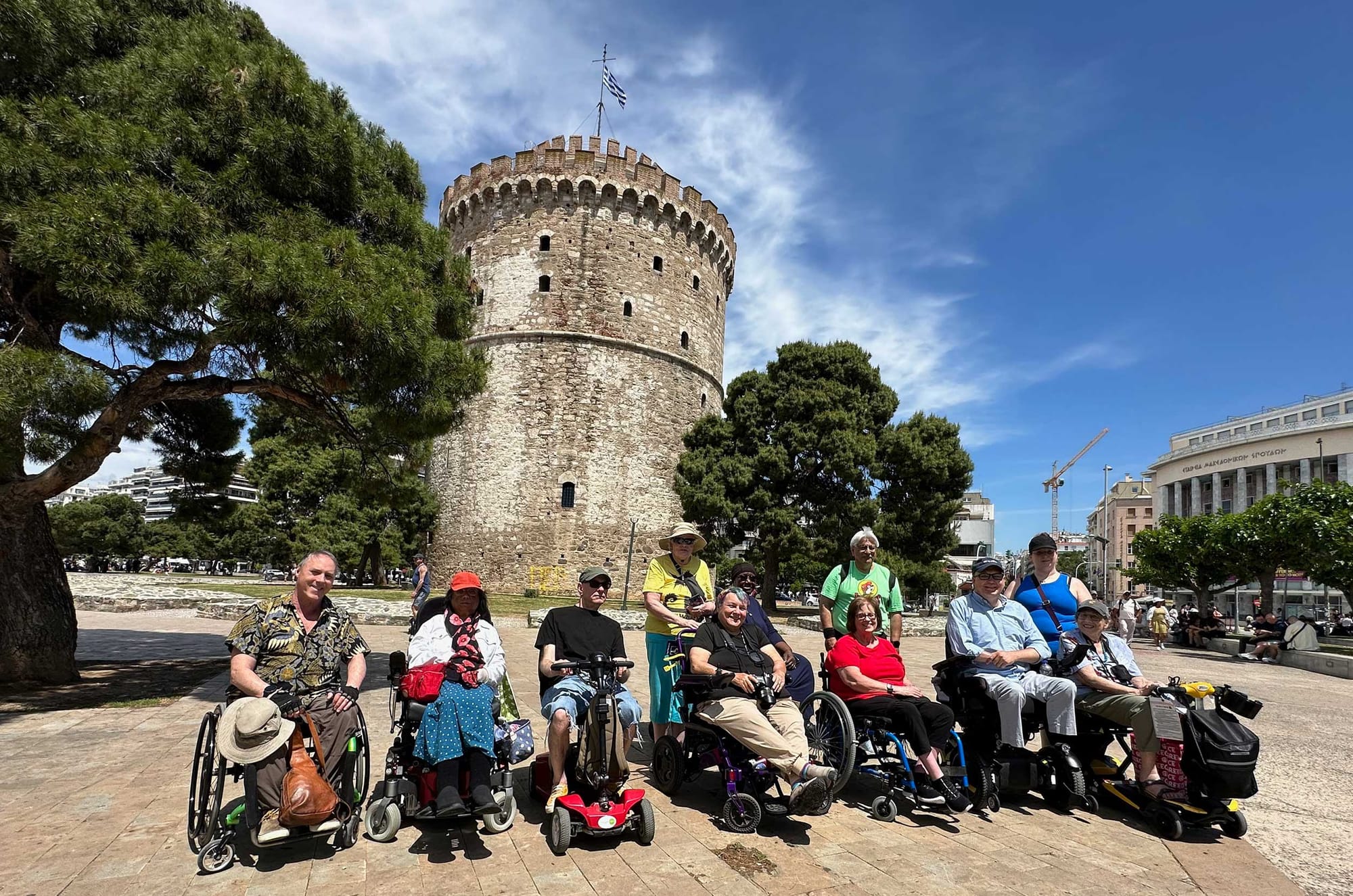 Group of wheelchair users in front of historic White Tower.
