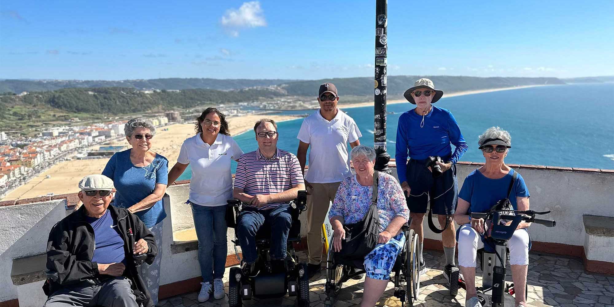 John with a group of travelers overlooking a Portuguese beach town.