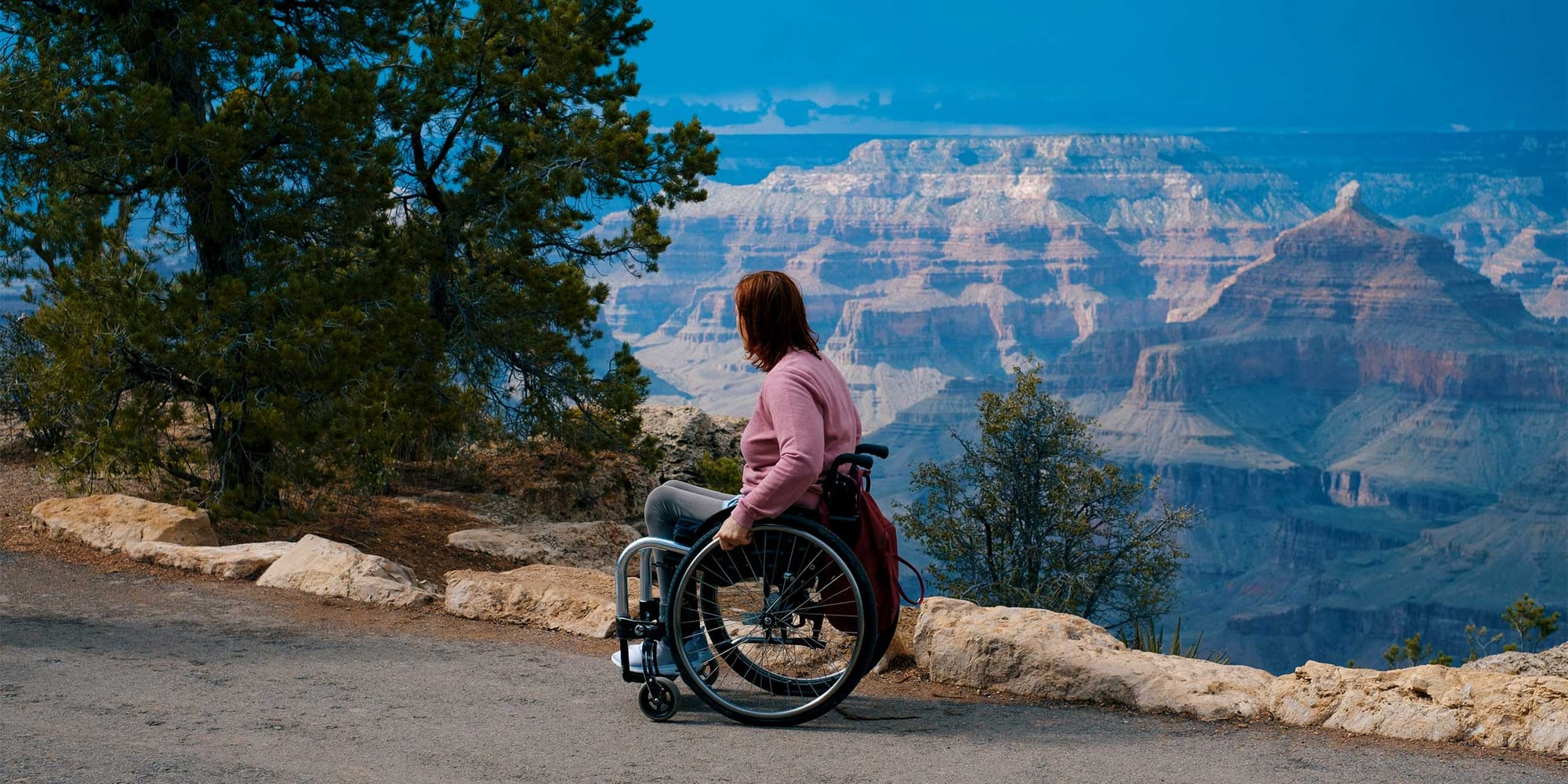 Wheelchair user on a trail near a Grand Canyon.