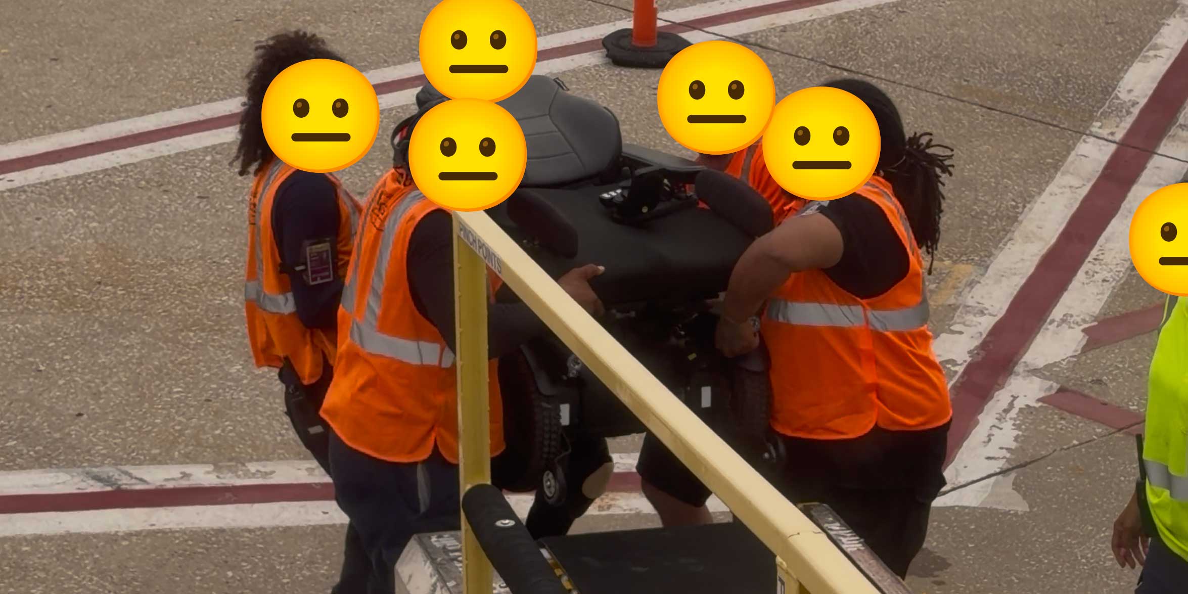 United Airlines baggage handlers manually carrying a power wheelchair.