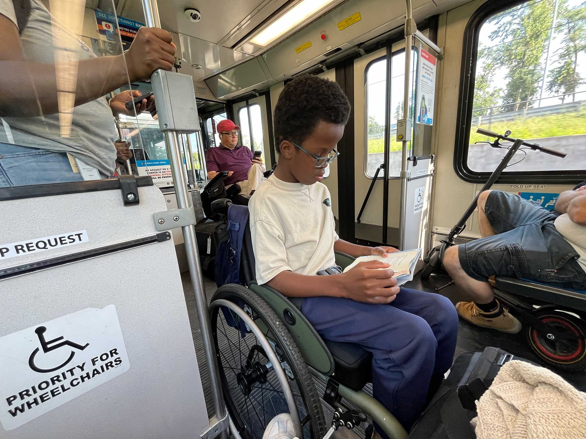 Robert reading a book while on the metro train.