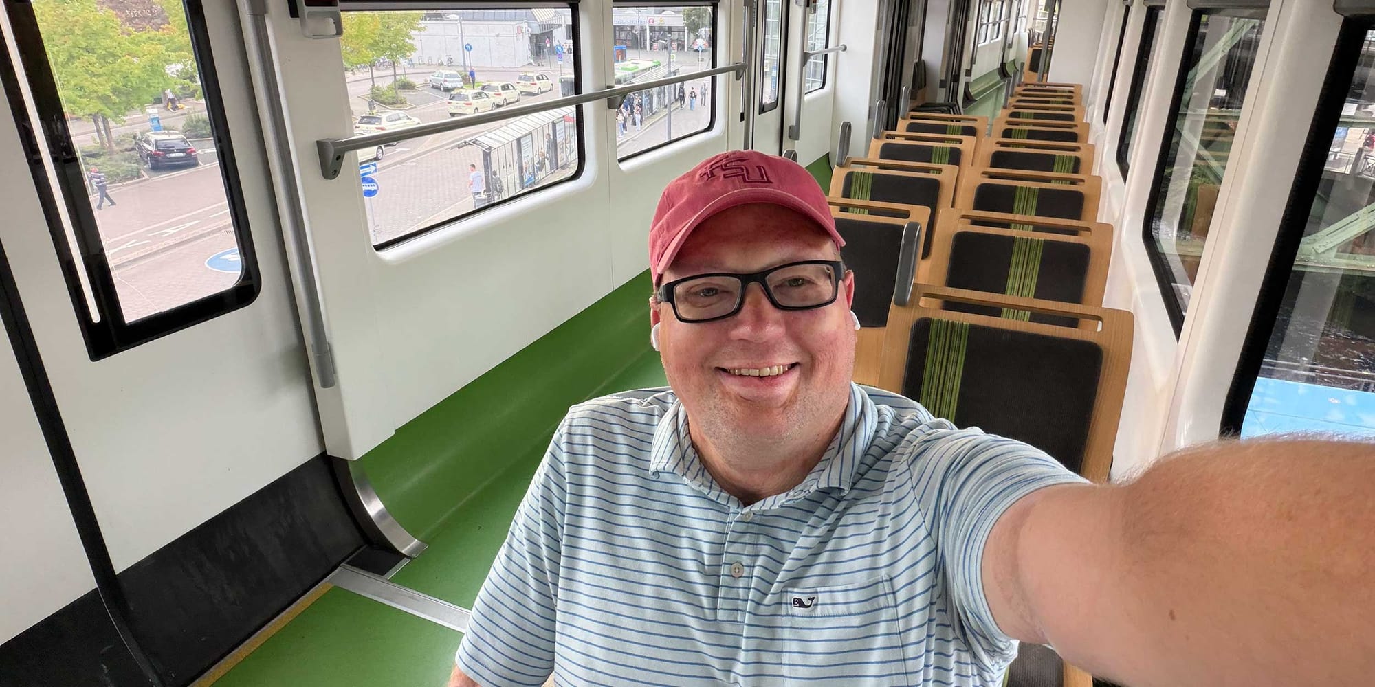 Selfie of John sitting in his wheelchair inside a train in Wuppertal, Germany.