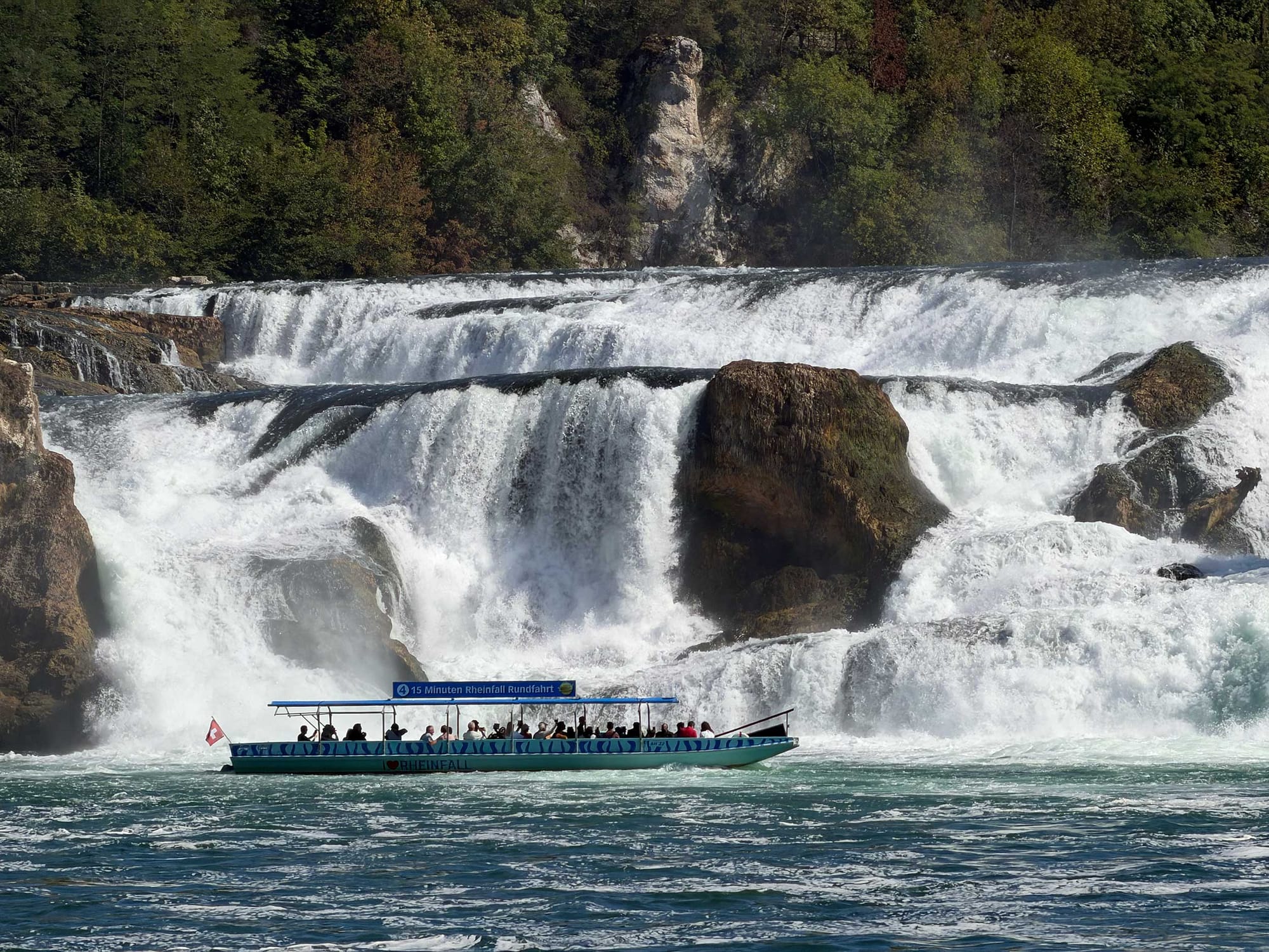 Sightseeing boat at the edge of the Rhine Falls.