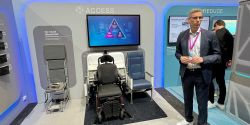 Airbus team briefing media in front of accessibility exhibit.