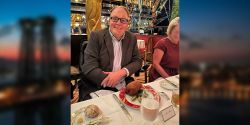 John seated at a table inside the Russian Tea Room in New York City.
