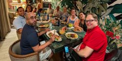 John seated around a table with a group of people in Colombia.