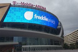 PHOTO DESCRIPTION: Facade of the T-Mobile Arena, with the Freddie Awards logo displayed on the large external video board.