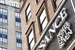 PHOTO DESCRIPTION: A close-up, angled shot of a section of a brick building, with a sign on the front that says 'Renaissance
