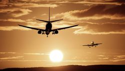 Airplanes against a sunset sky