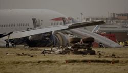 Crashed airplane with emergency evacuation slides deployed.