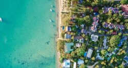 Aerial view of vacation homes along the beach shore.