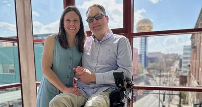 John and Stevie pictured with the Knoxville gold ball and skyline in the background.