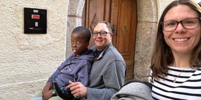 Stevie taking a selfie with John and Robert in the background.