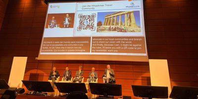 John presenting onstage at the World Summit on Accessible Tourism.