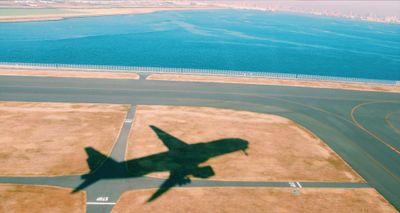 Shadow of an airplane on the ground after takeoff.