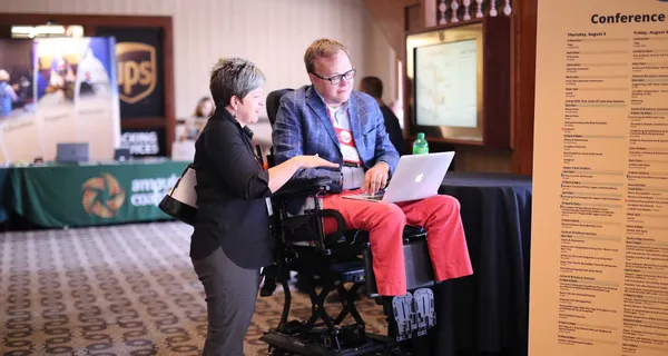 John consulting with a client at a conference.