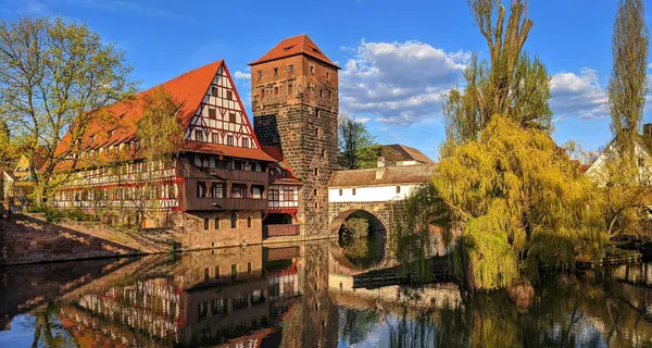Historic Bavarian building and arched bridge over water in Nuremberg, Germany Old Town.