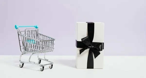 Shopping cart with wrapped gift.