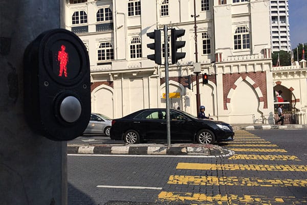 PHOTO DESCRIPTION: Sidewalk with crossing light illuminated into the red icon position.