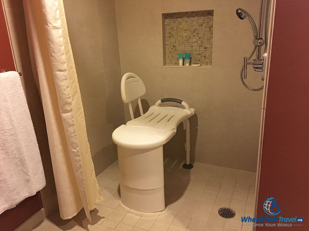 Portable shower bench inside roll-in shower at Hyatt Regency DFW Airport Hotel