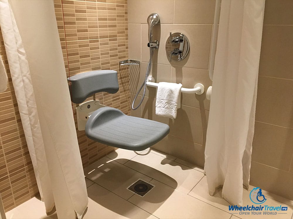 Roll-in shower with built-in seat and grab bars